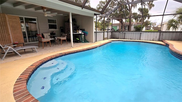 view of pool with a ceiling fan, a fenced in pool, glass enclosure, and a patio