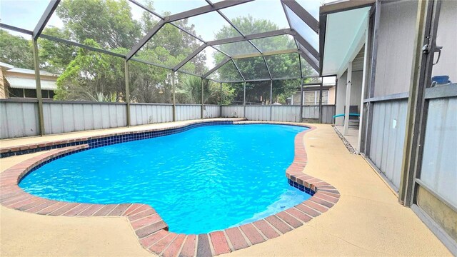 view of pool with a lanai and a patio