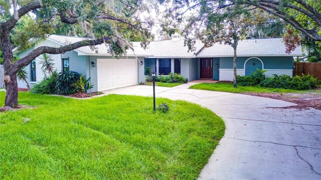 ranch-style home with a garage and a front yard