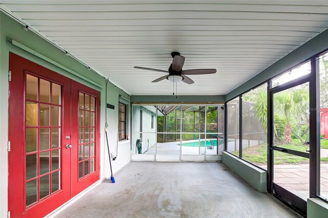 unfurnished sunroom with ceiling fan and a healthy amount of sunlight