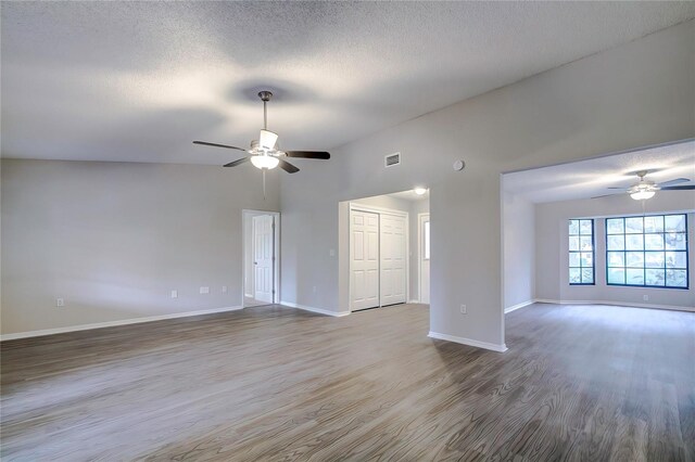 unfurnished room with hardwood / wood-style flooring, ceiling fan, and a textured ceiling