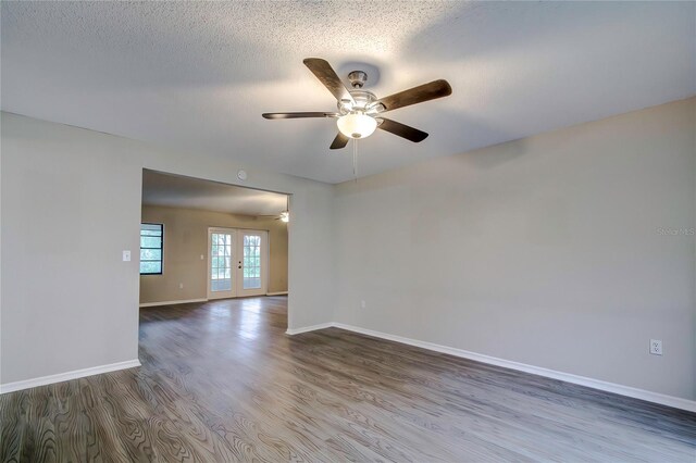 unfurnished room with ceiling fan, french doors, a textured ceiling, and hardwood / wood-style flooring