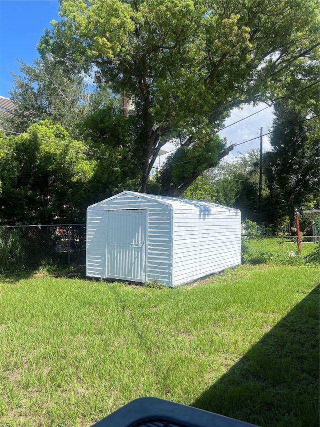 view of outbuilding with a lawn