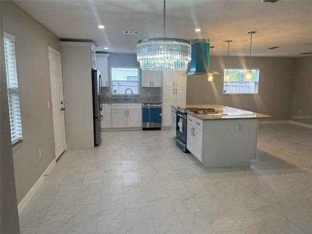 kitchen featuring a center island, hanging light fixtures, white cabinetry, island exhaust hood, and stainless steel appliances