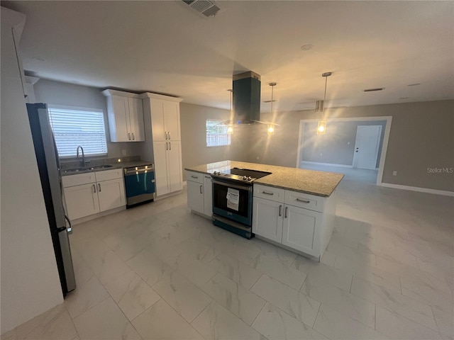 kitchen featuring white cabinetry, sink, stainless steel appliances, decorative light fixtures, and a kitchen island