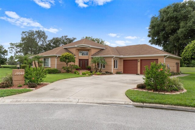 view of front of house with a garage and a front yard