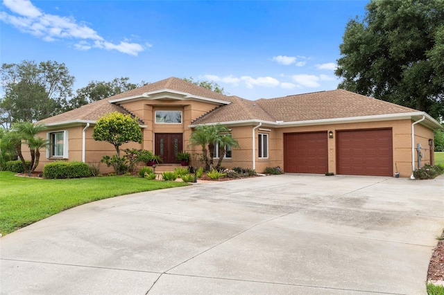 view of front facade featuring a garage and a front lawn