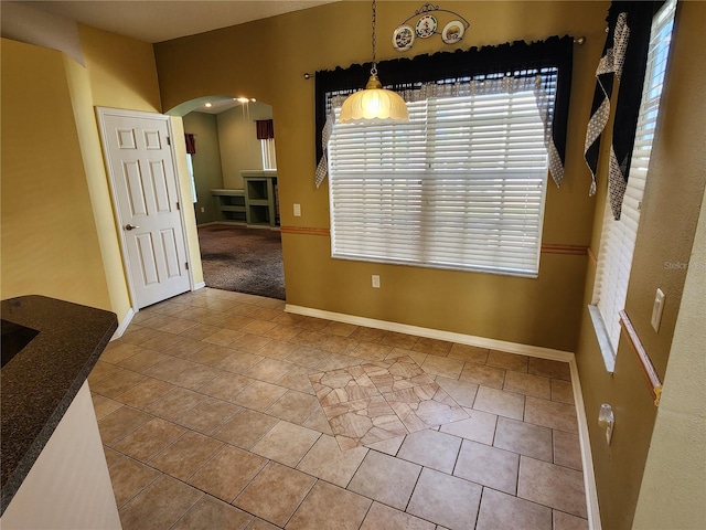 unfurnished dining area with tile patterned floors