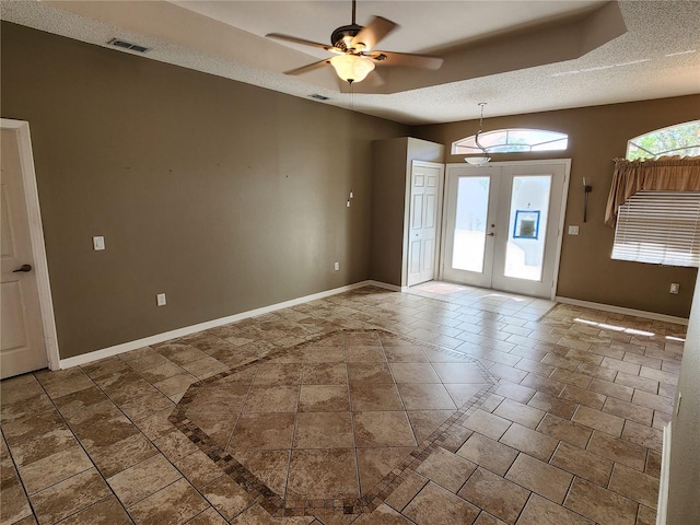 foyer featuring tile patterned floors, a textured ceiling, french doors, and ceiling fan