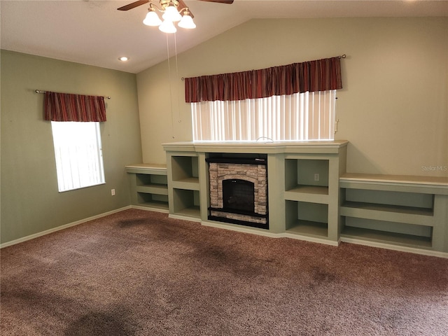 unfurnished living room with a fireplace, ceiling fan, carpet, and lofted ceiling