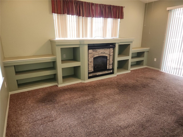 unfurnished living room with a fireplace and carpet flooring