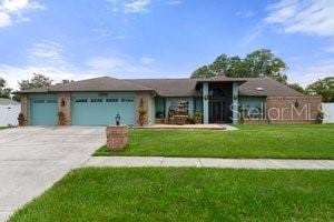 ranch-style home with a garage and a front yard