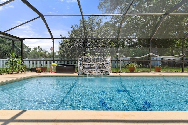 view of swimming pool featuring pool water feature and glass enclosure