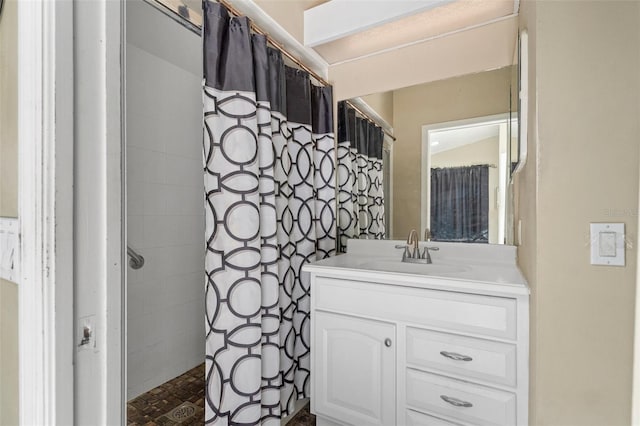 bathroom featuring vanity and curtained shower