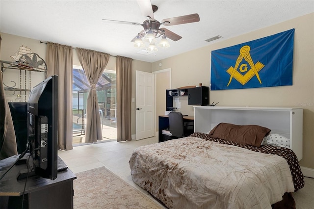 bedroom with built in desk, light tile patterned floors, access to exterior, ceiling fan, and a textured ceiling