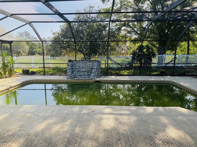 6096 Kinlock Ave, Spring Hill, FL 34608 - view of swimming pool featuring a fenced in pool, a fenced backyard, and a lanai