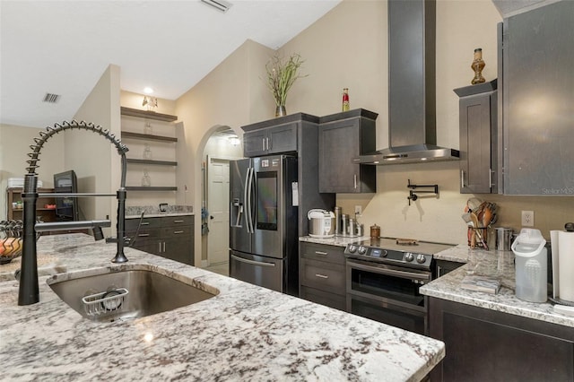 6096 Kinlock Ave, Spring Hill, FL 34608 - kitchen with visible vents, open shelves, wall chimney range hood, arched walkways, and stainless steel appliances