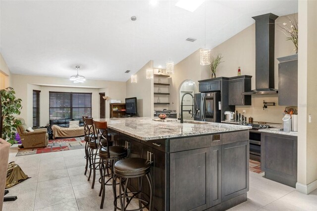6096 Kinlock Ave, Spring Hill, FL 34608 - kitchen featuring wall chimney range hood, a breakfast bar area, stainless steel appliances, open floor plan, and lofted ceiling