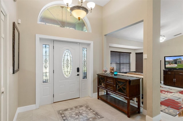 6096 Kinlock Ave, Spring Hill, FL 34608 - entryway featuring an inviting chandelier, baseboards, a towering ceiling, and visible vents