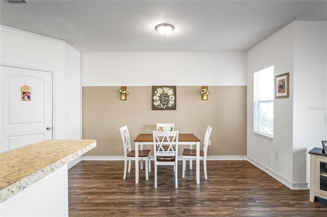 dining area featuring dark hardwood / wood-style flooring