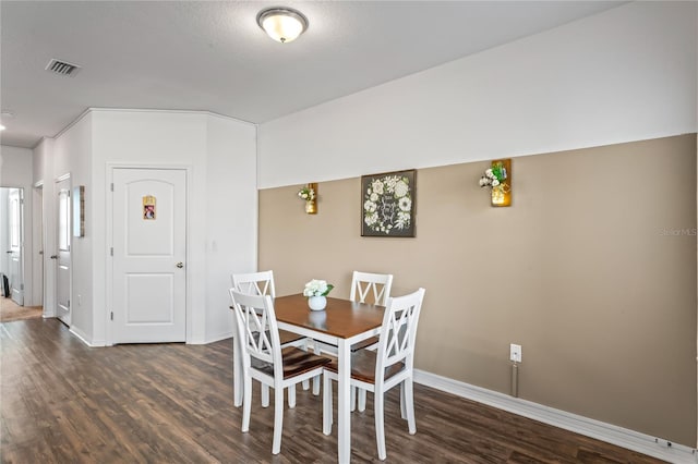 dining space featuring dark hardwood / wood-style floors