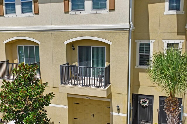 view of front facade with a balcony and a garage