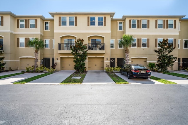 multi unit property with a balcony and a garage