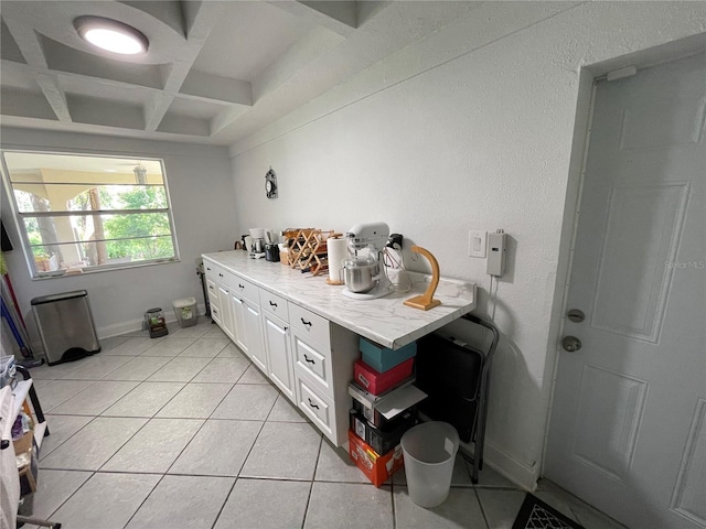 bathroom with tile patterned flooring, coffered ceiling, and beamed ceiling