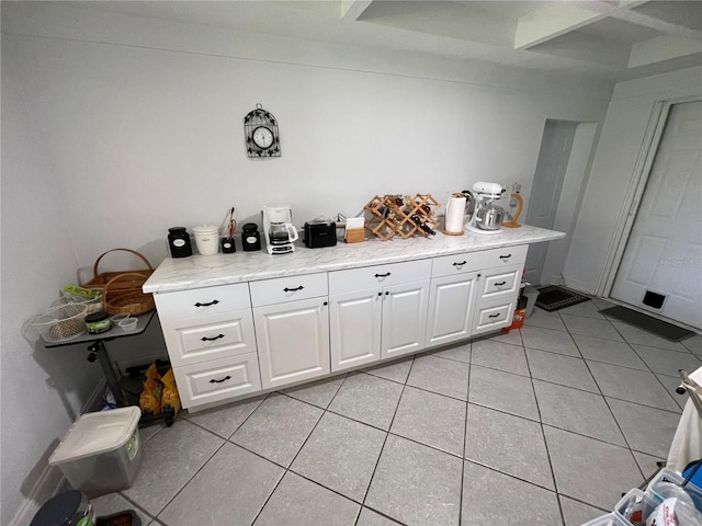 kitchen with white cabinets and light tile patterned flooring