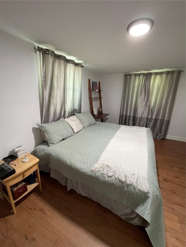 bedroom with hardwood / wood-style flooring