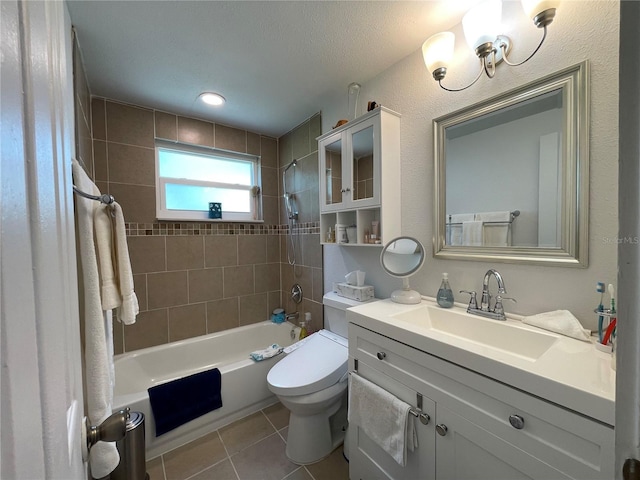 full bathroom featuring tile patterned floors, tiled shower / bath combo, vanity, and toilet