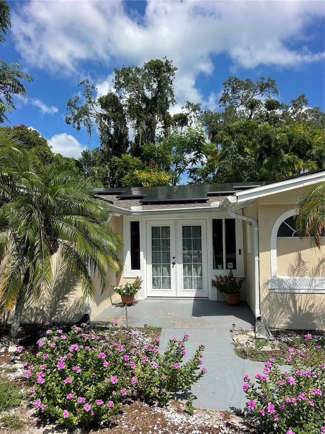 rear view of property featuring french doors and a patio area