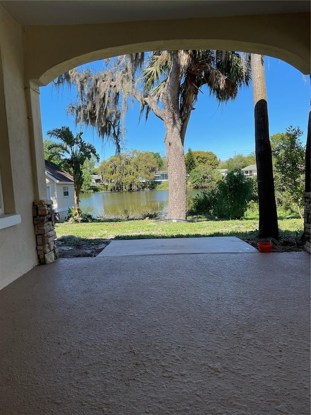 view of yard featuring a water view and a patio