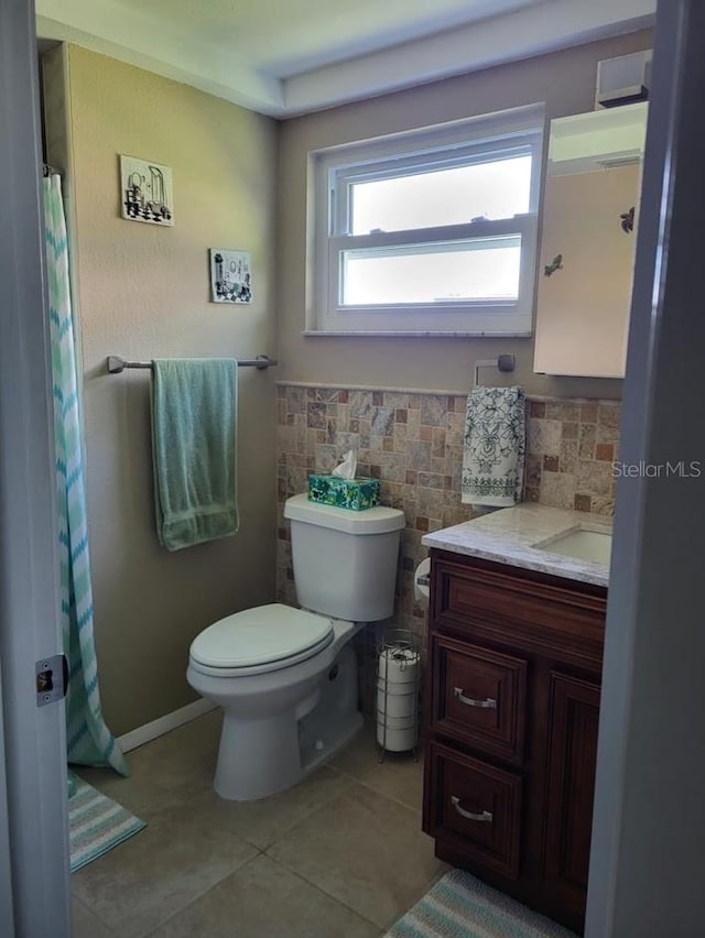 bathroom with tile patterned flooring, vanity, tasteful backsplash, and toilet