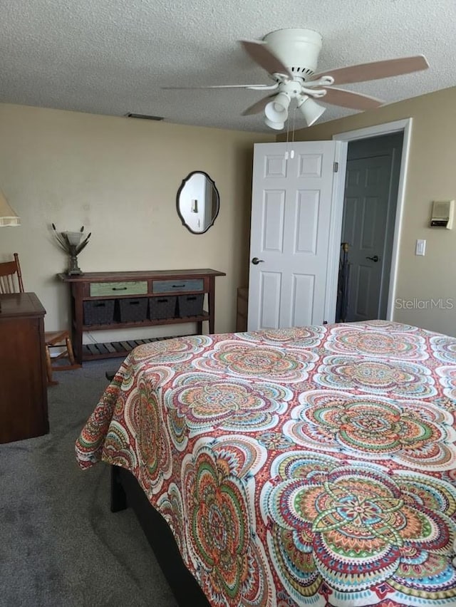 bedroom featuring carpet, a textured ceiling, and ceiling fan