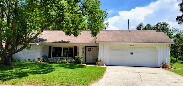 ranch-style house with an attached garage, concrete driveway, board and batten siding, and a front yard