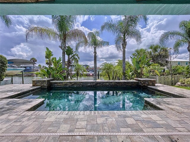 view of swimming pool featuring a water view