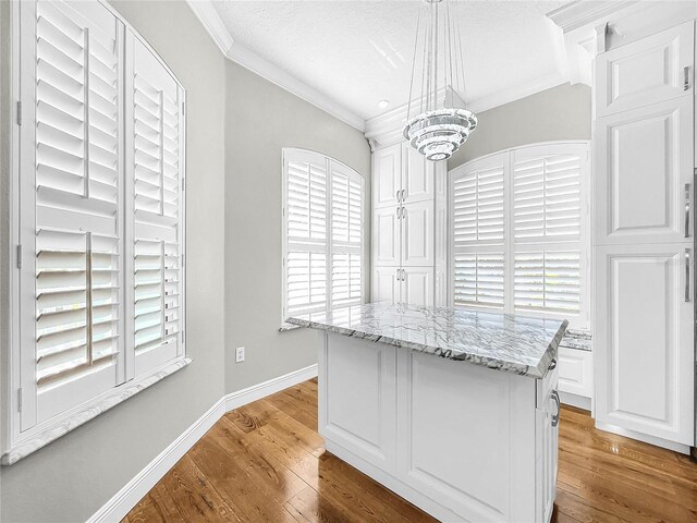 spacious closet with a notable chandelier and light wood-type flooring