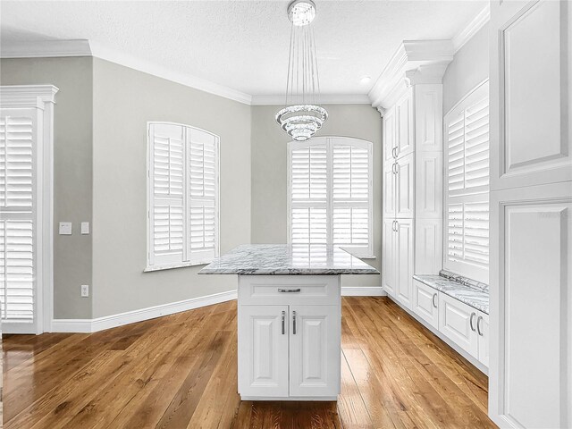 walk in closet featuring an inviting chandelier and light hardwood / wood-style floors