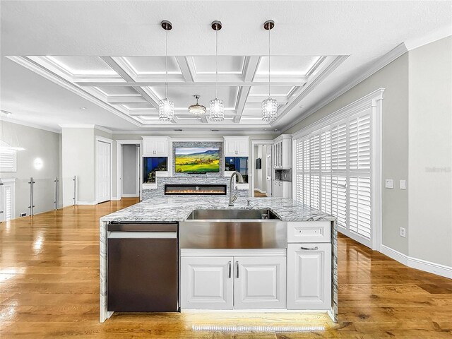 kitchen featuring white cabinetry, sink, and pendant lighting