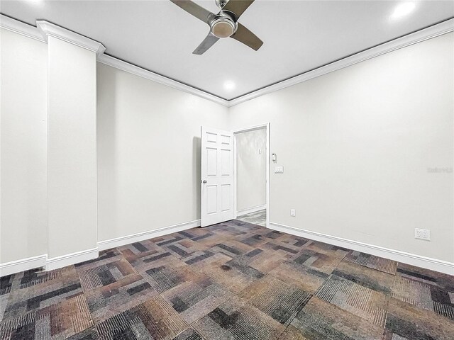 carpeted spare room with crown molding and ceiling fan