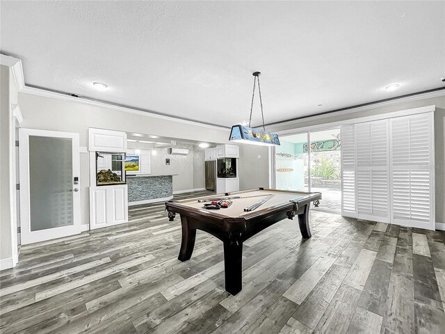 recreation room with ornamental molding, a textured ceiling, light wood-type flooring, and billiards