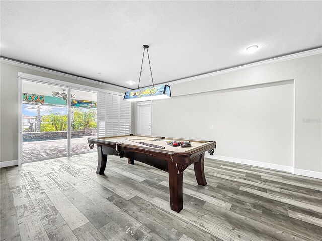 game room with pool table, ornamental molding, and hardwood / wood-style floors