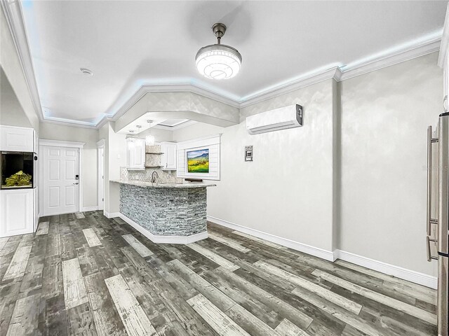 bar featuring crown molding, dark wood-type flooring, backsplash, a wall unit AC, and white cabinets