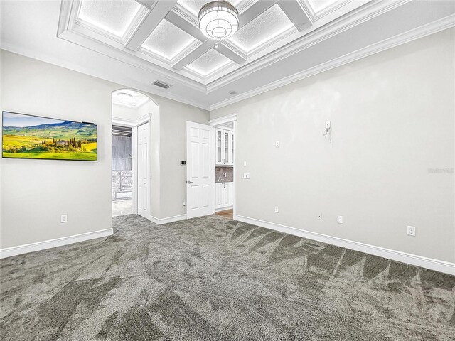 carpeted spare room with beamed ceiling, ornamental molding, and coffered ceiling