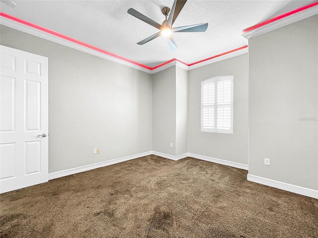 empty room featuring ornamental molding, carpet floors, ceiling fan, and a textured ceiling