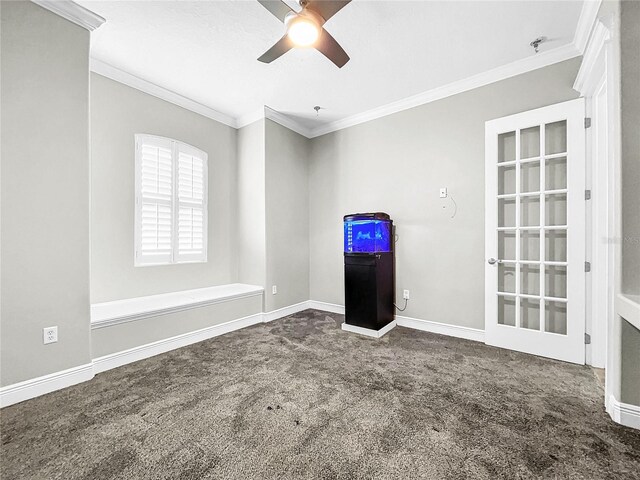 spare room featuring ornamental molding, carpet, and ceiling fan