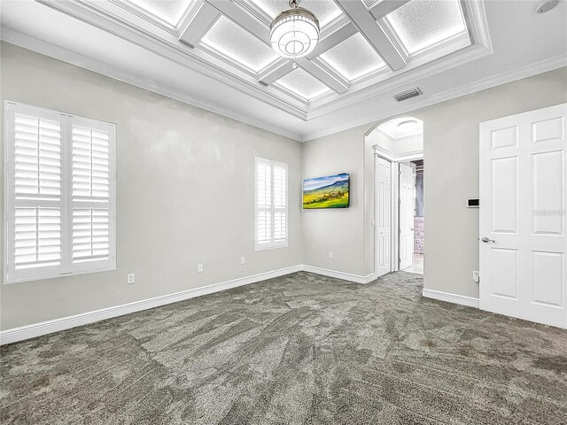 unfurnished room with dark colored carpet, coffered ceiling, and crown molding