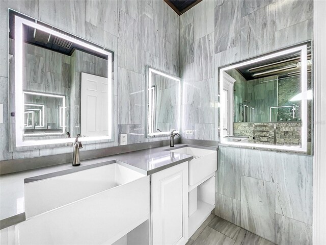 bathroom with vanity and tile walls