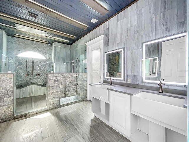 bathroom with tiled shower, vanity, tile walls, and wooden ceiling